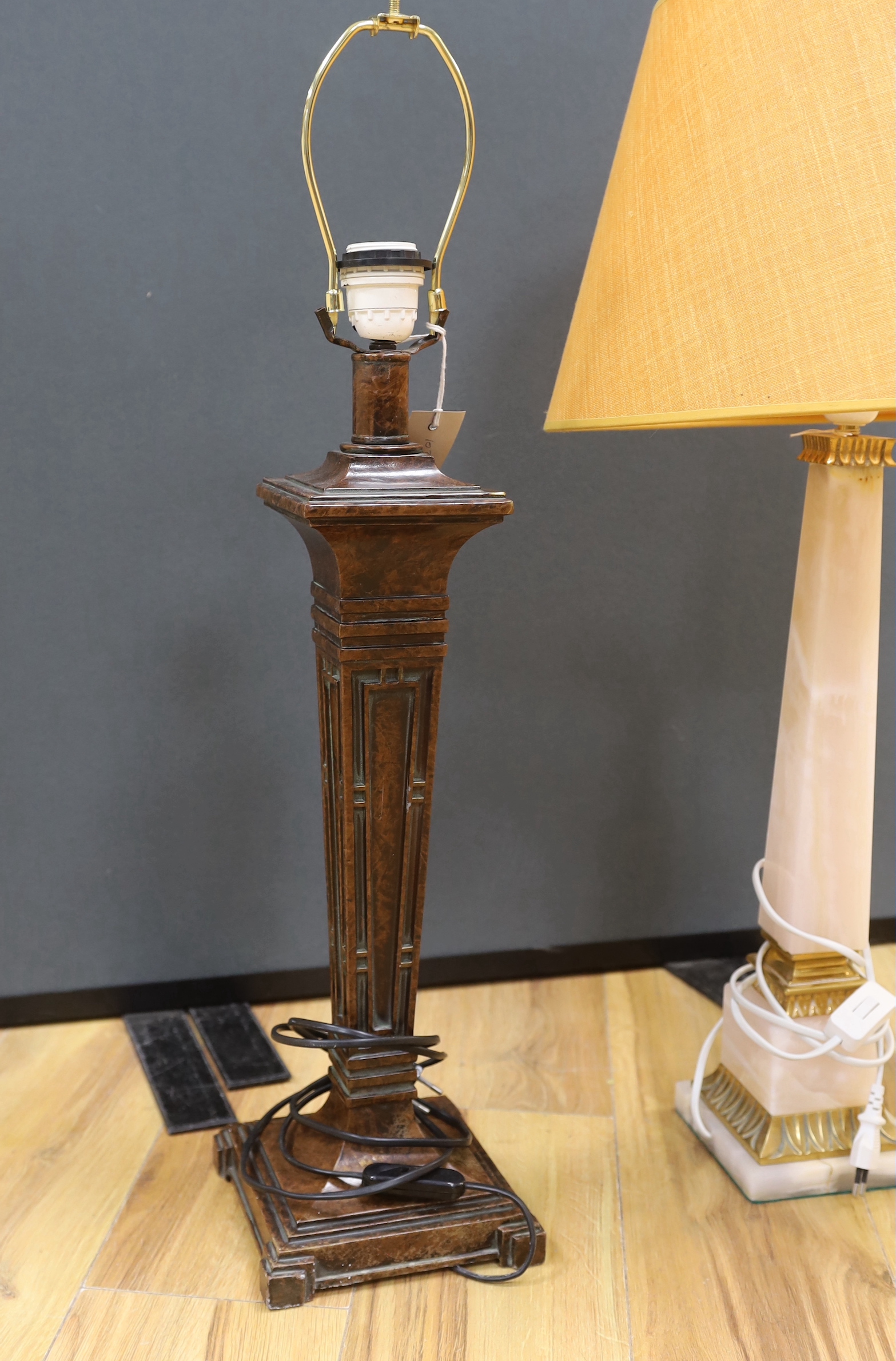 Two Art Deco style lamps comprising a spelter example and an onyx example, the largest 54cm excluding the fitting